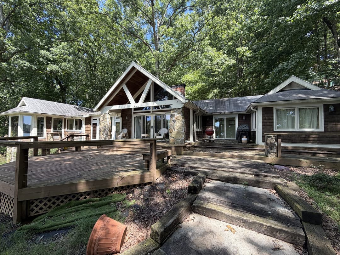 Dining area and sunroom with expansive windows overlooking Lake Lanier