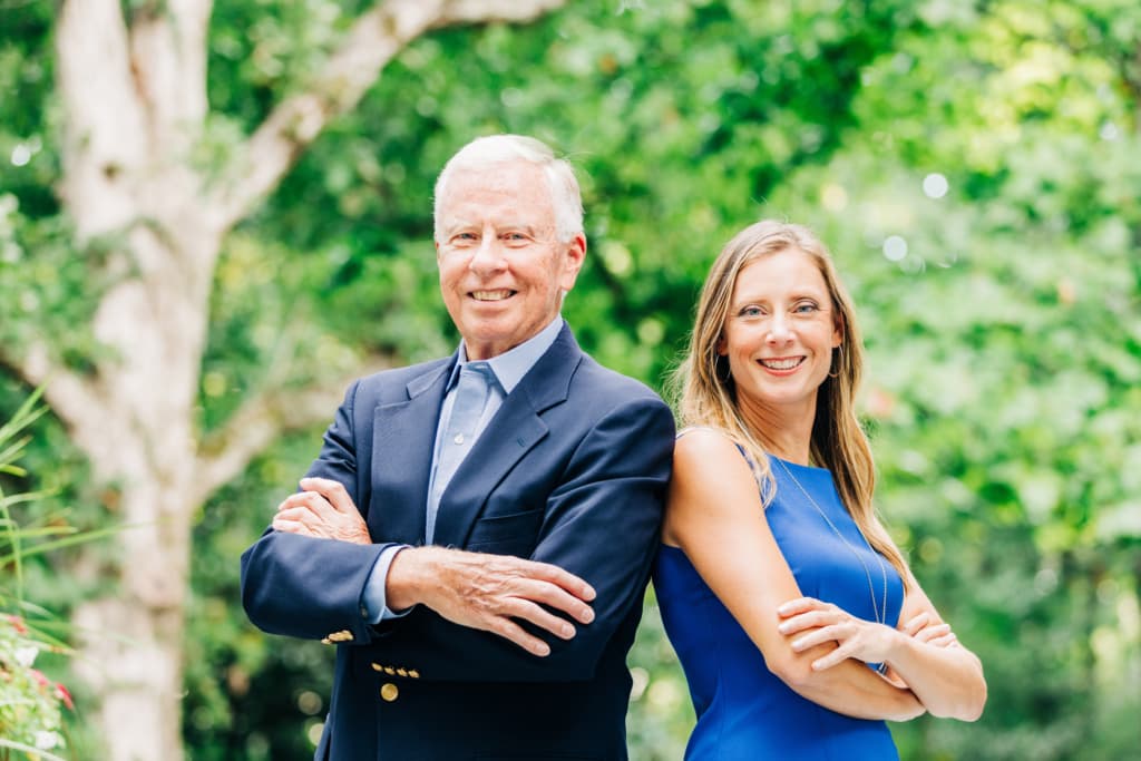 C.L. Smith and Ashley Smith of DreamSmith Realty standing back to back outdoors