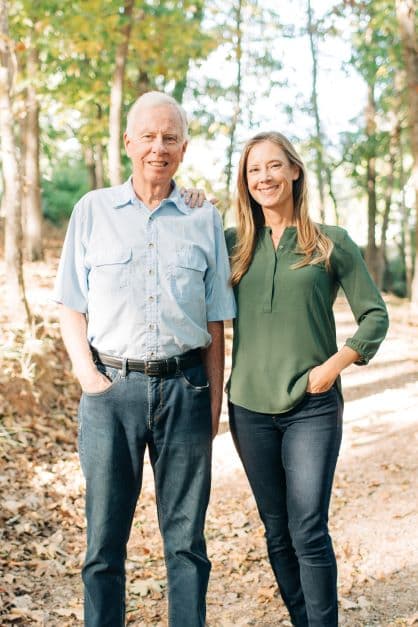C.L. Smith and Ashley Smith standing together on a wooded trail