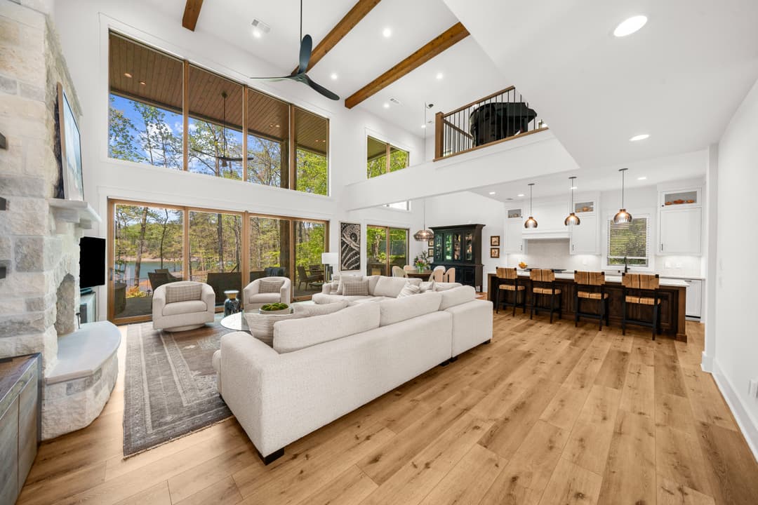 Open-concept main living room with floor-to-ceiling windows overlooking Lake Lanier