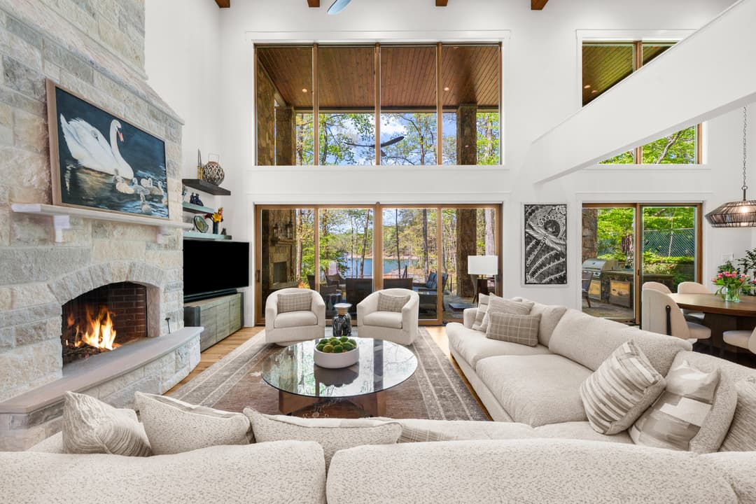 Living room sliding glass doors opening to the covered terrace and lake