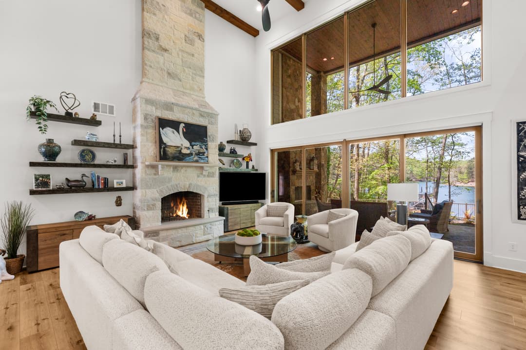 Great room with custom built-ins flanking the fireplace and lake-facing windows