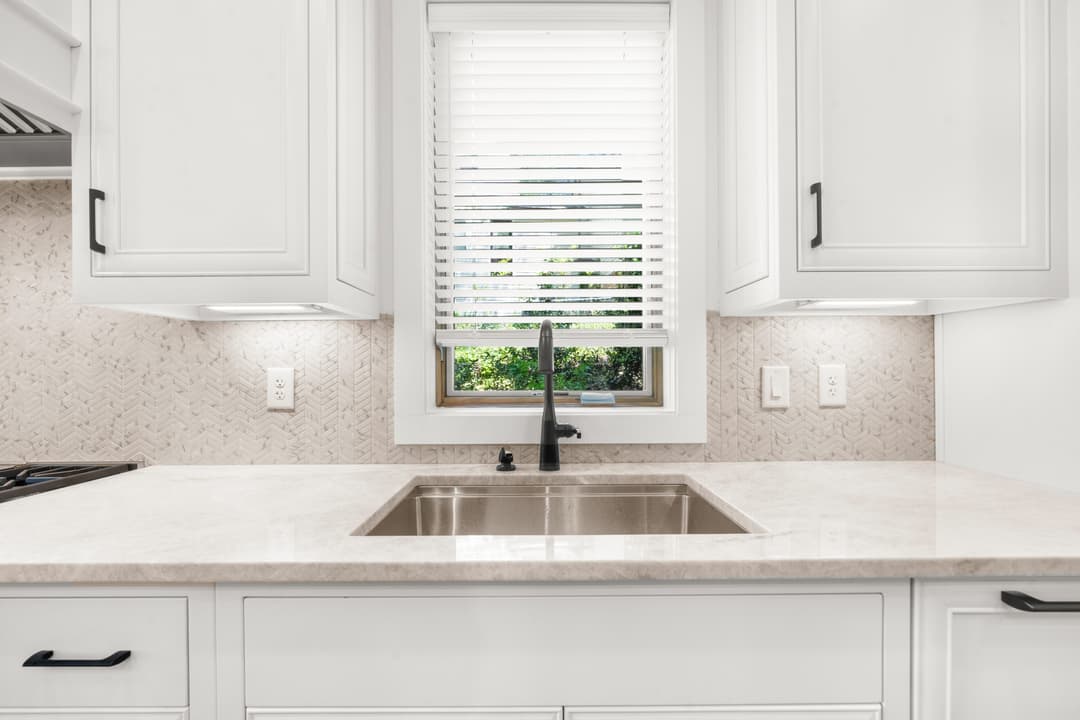Kitchen prep zone with farmhouse sink and lake-view window