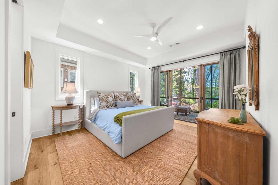 Upstairs guest bedroom with vaulted ceiling and natural light