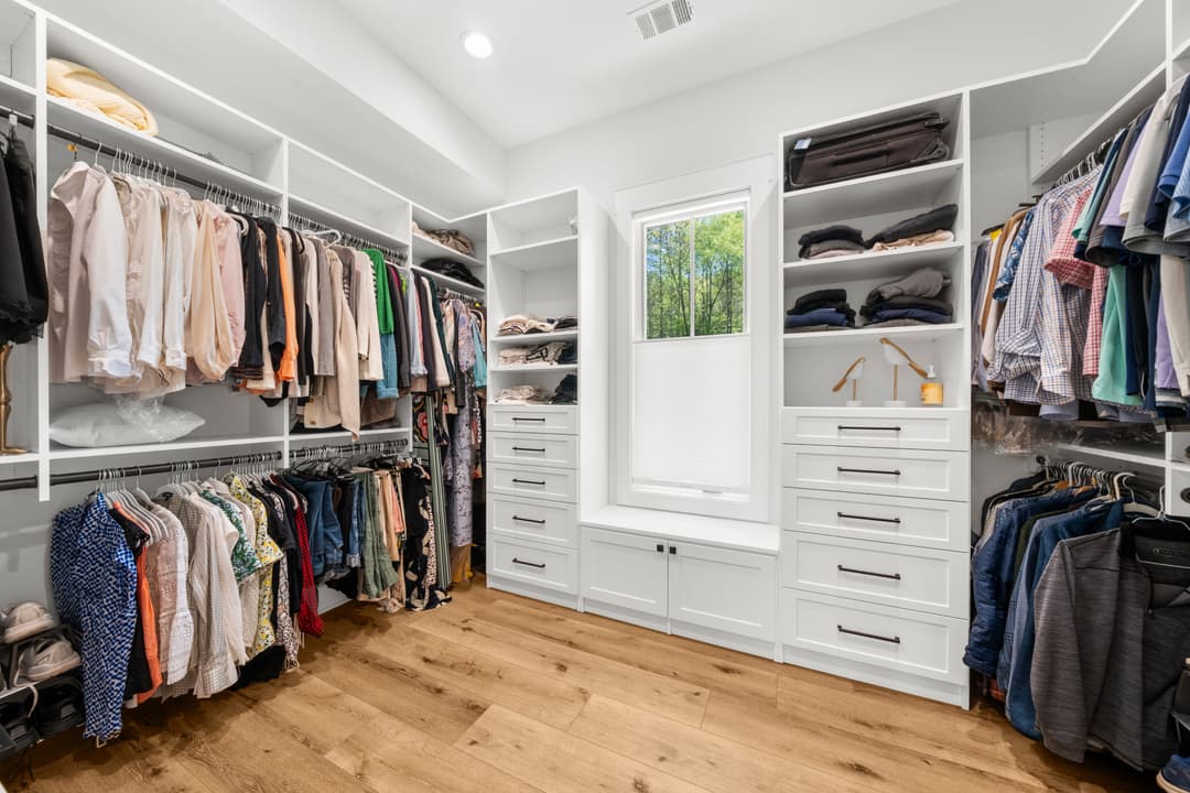 Custom walk-in closet with island and ceiling-height built-ins