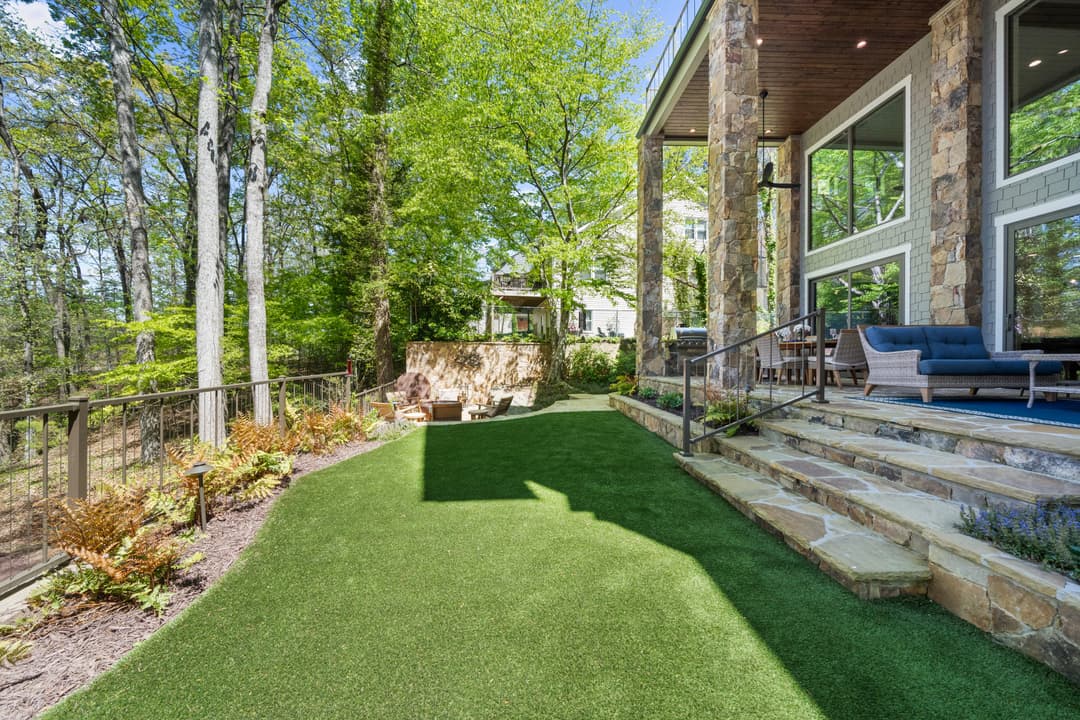 Upper-level game room with billiards table, lounge seating, and lake-view terrace doors