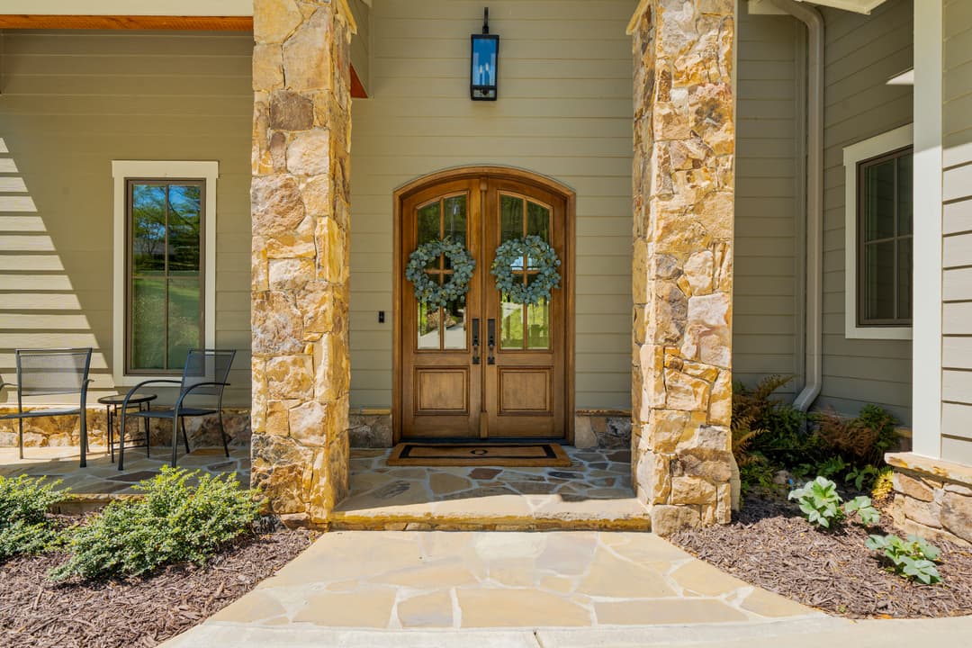 Twilight exterior of custom 2022 lake house on Lake Lanier with warmly lit windows