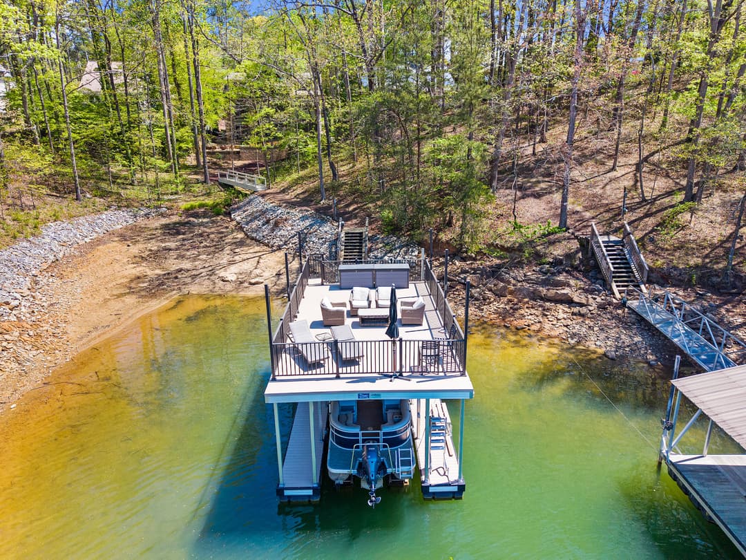 Drone view of the home tucked into mature trees on Lake Lanier