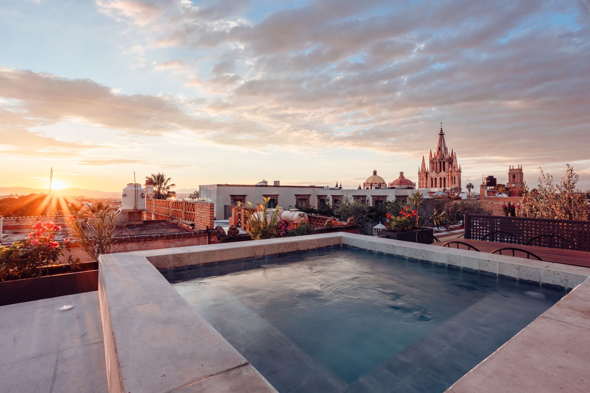 Rooftop plunge pool at sunset with the spires of San Miguel de Allende in the distance
