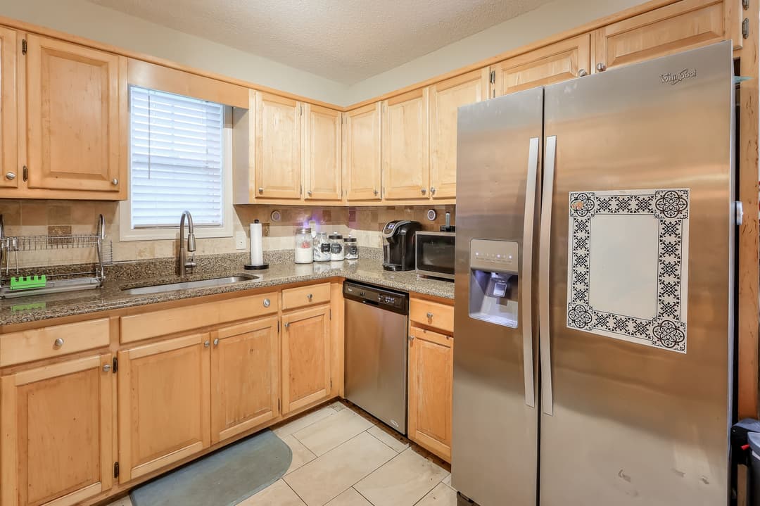 02c Kitchen has granite countertops and stainless steel appliances 8493 Dawsonville Hwy 9 scaled at 8493 dawsonville highway